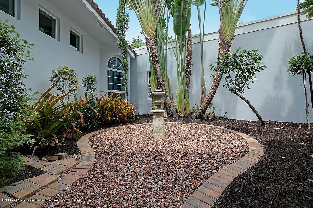 2570 Hampton Bridge Road Delray Beach, FL 33445 - Photo 39 of 40 a view of a backyard with plants and a potted plant
