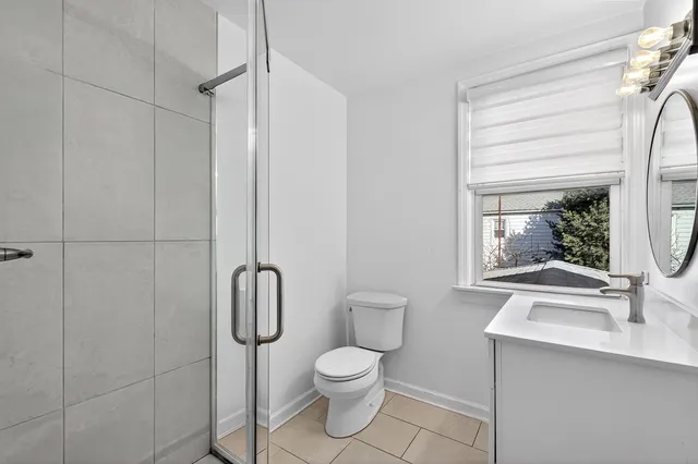 a bathroom with a toilet sink and shower