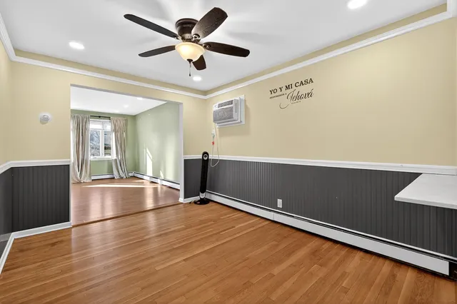 a view of room with wooden floor and ceiling fan