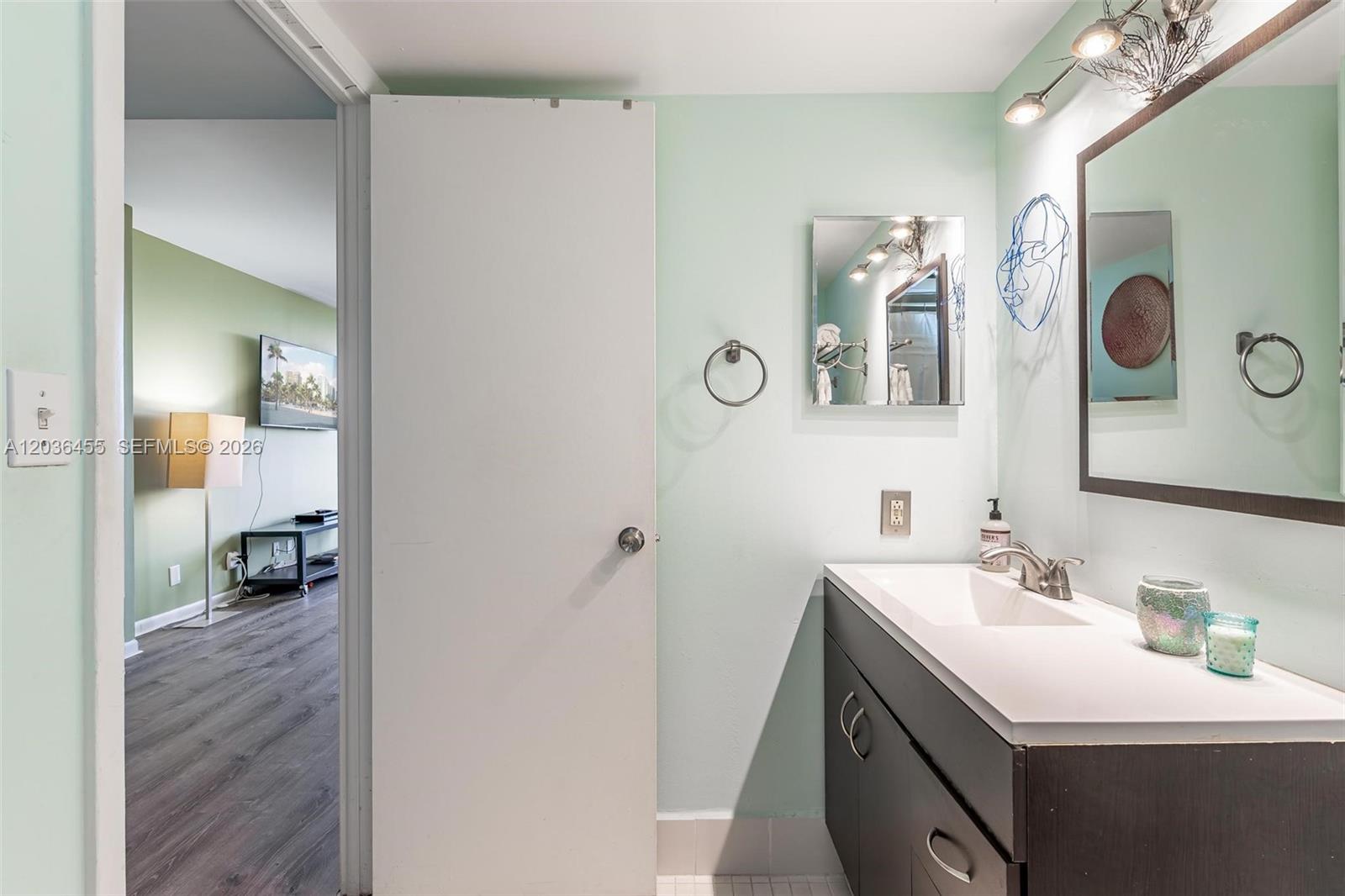 780 Northeast 69th Street, Unit 1010 Miami, FL 33138 - Photo 25 of 31 a bathroom with a sink and a mirror