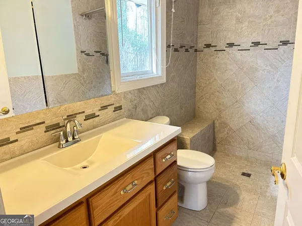 a bathroom with a sink and toilet