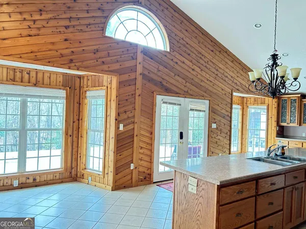a kitchen with stainless steel appliances granite countertop a stove a sink and a wooden cabinets