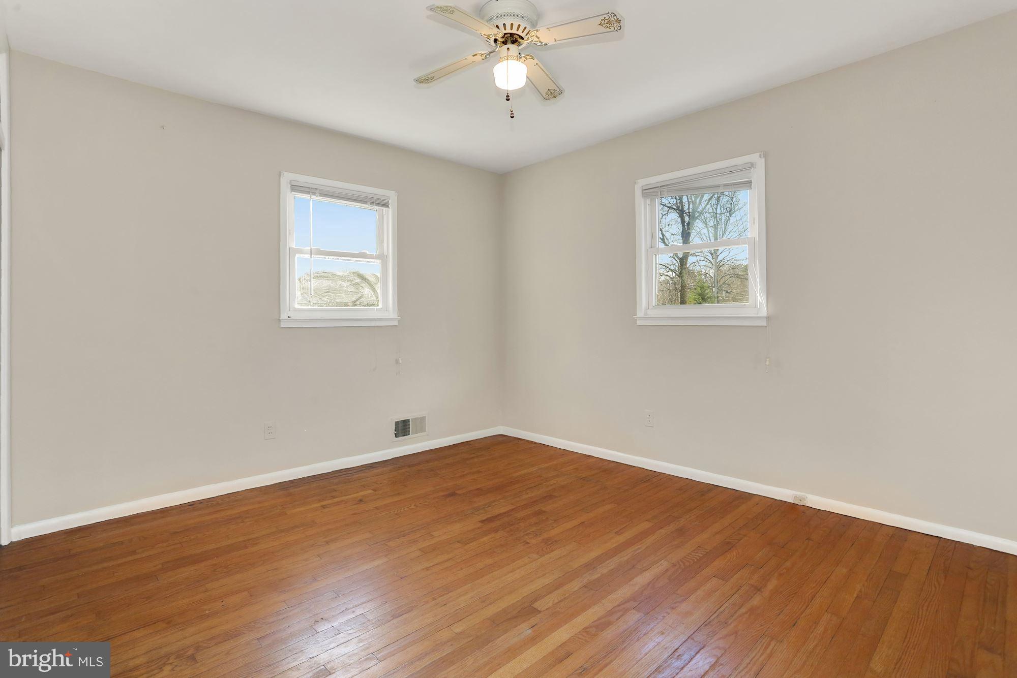 2032 Greenwich Street Falls Church, VA 22043 - Photo 15 of 26 a view of an empty room with wooden floor and a ceiling fan
