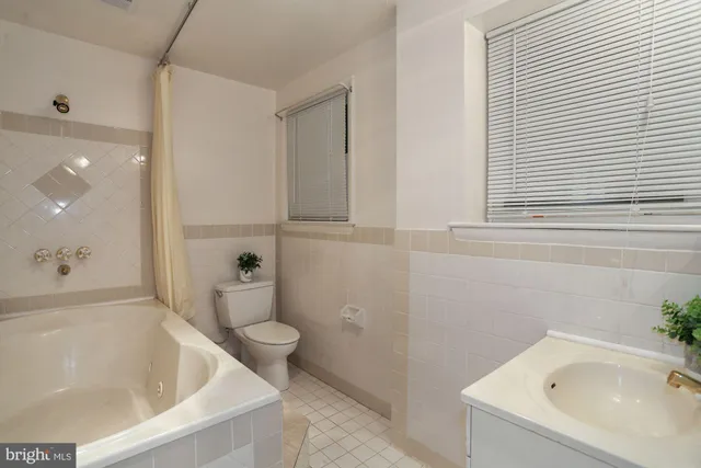 a bathroom with a tub and sink