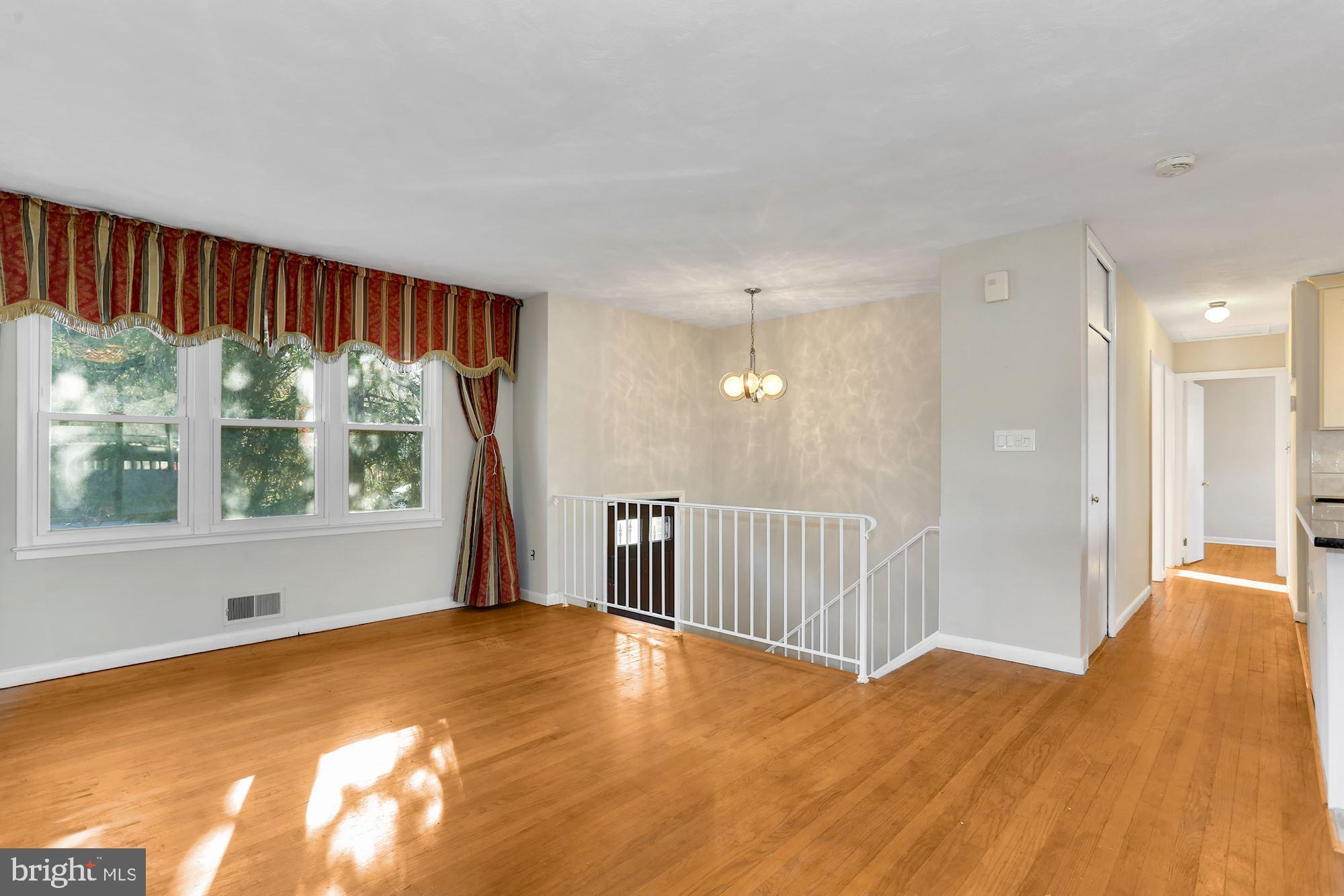 2032 Greenwich Street Falls Church, VA 22043 - Photo 4 of 26 a view of an empty room with wooden floor and a window