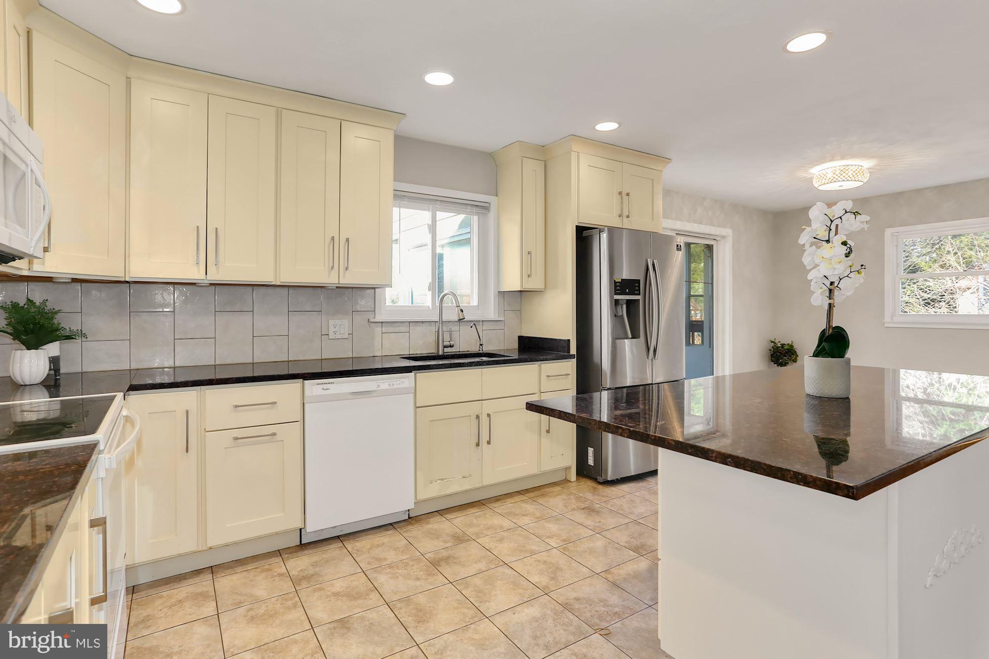 2032 Greenwich Street Falls Church, VA 22043 - Photo 7 of 26 a kitchen with stainless steel appliances granite countertop a sink refrigerator and cabinets