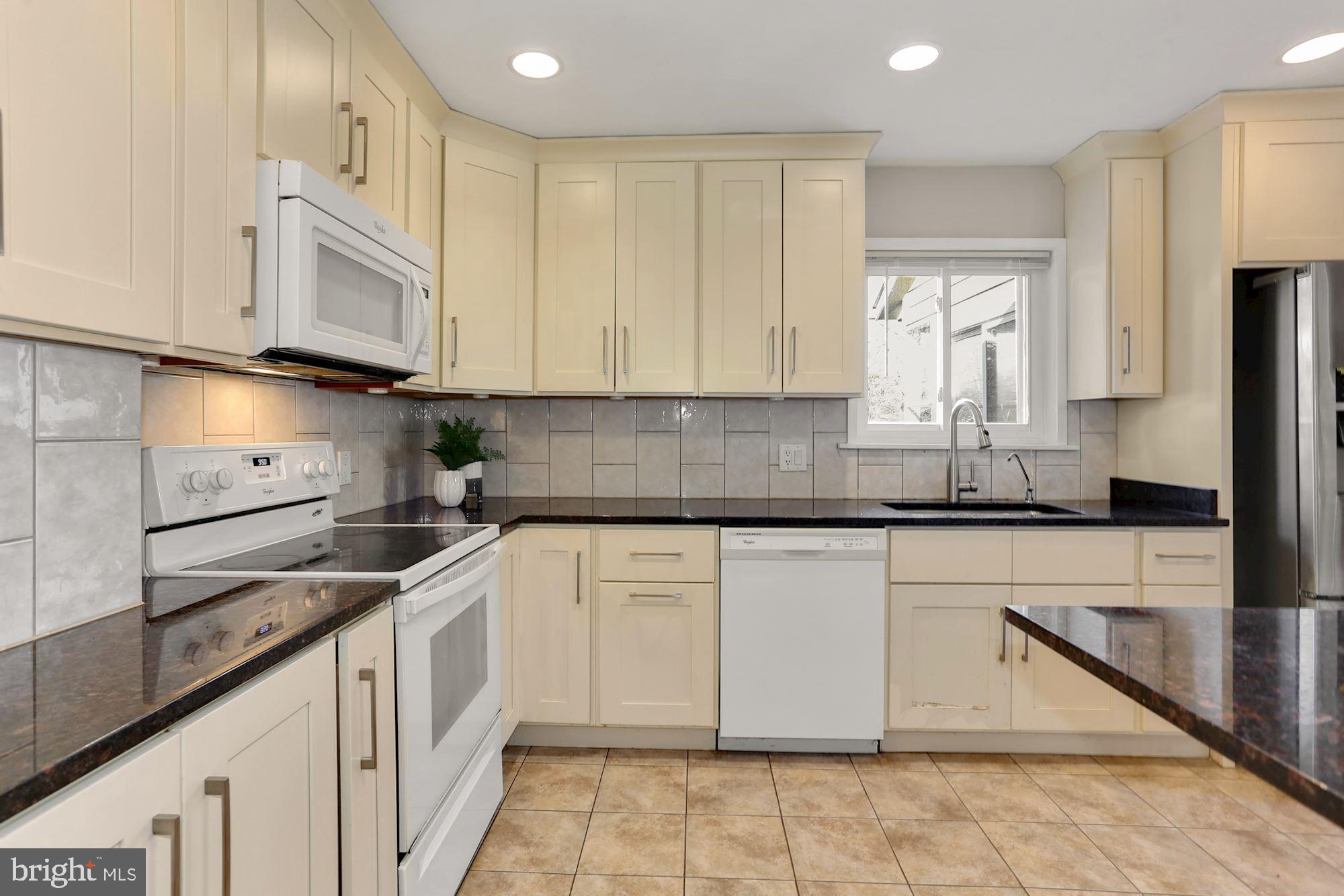2032 Greenwich Street Falls Church, VA 22043 - Photo 8 of 26 a kitchen with stainless steel appliances granite countertop white cabinets granite counter tops and a hard wood floors