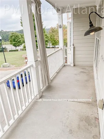 a view of a balcony with wooden floor and fence