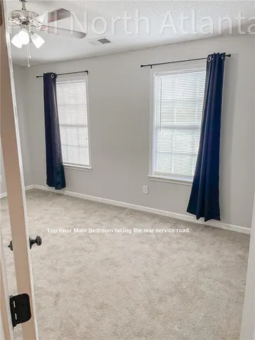 an empty room with windows and closet