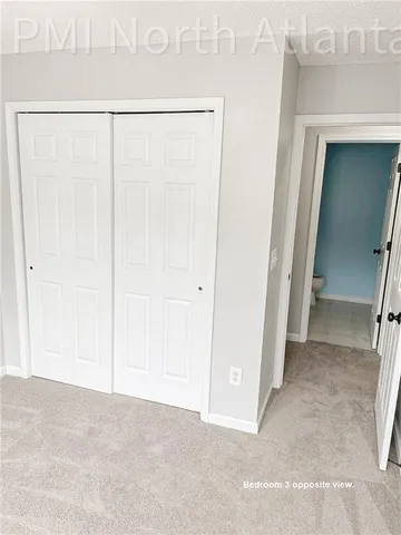 a view of a white house with a yard and lawn chairs