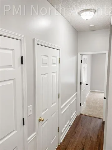 a view of a hallway with wooden floor