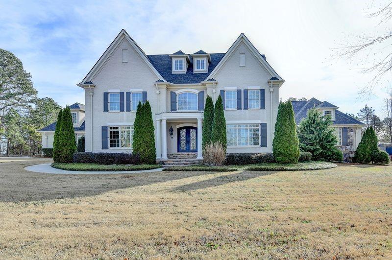 4045 Ridge Road Buford, GA 30519 - Photo 4 of 97 a front view of a house with a yard and garage