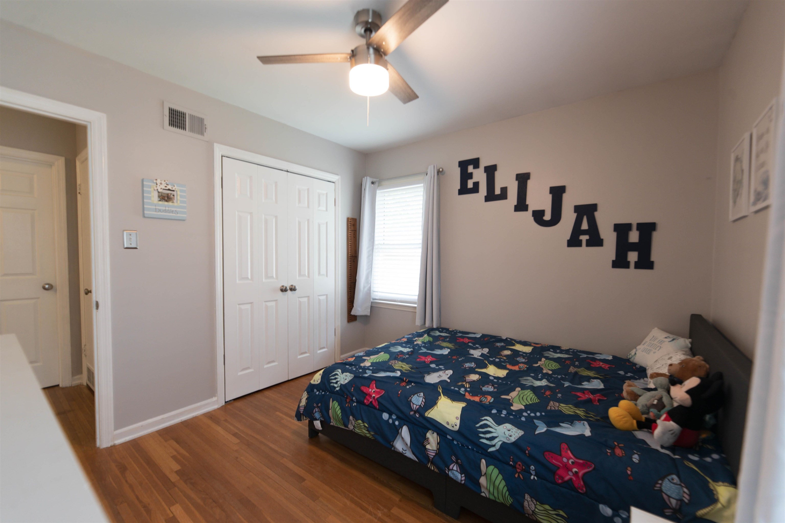 1446 Whitewater Road Memphis, TN 38117 - Photo 17 of 26 a bedroom with furniture and wooden floor
