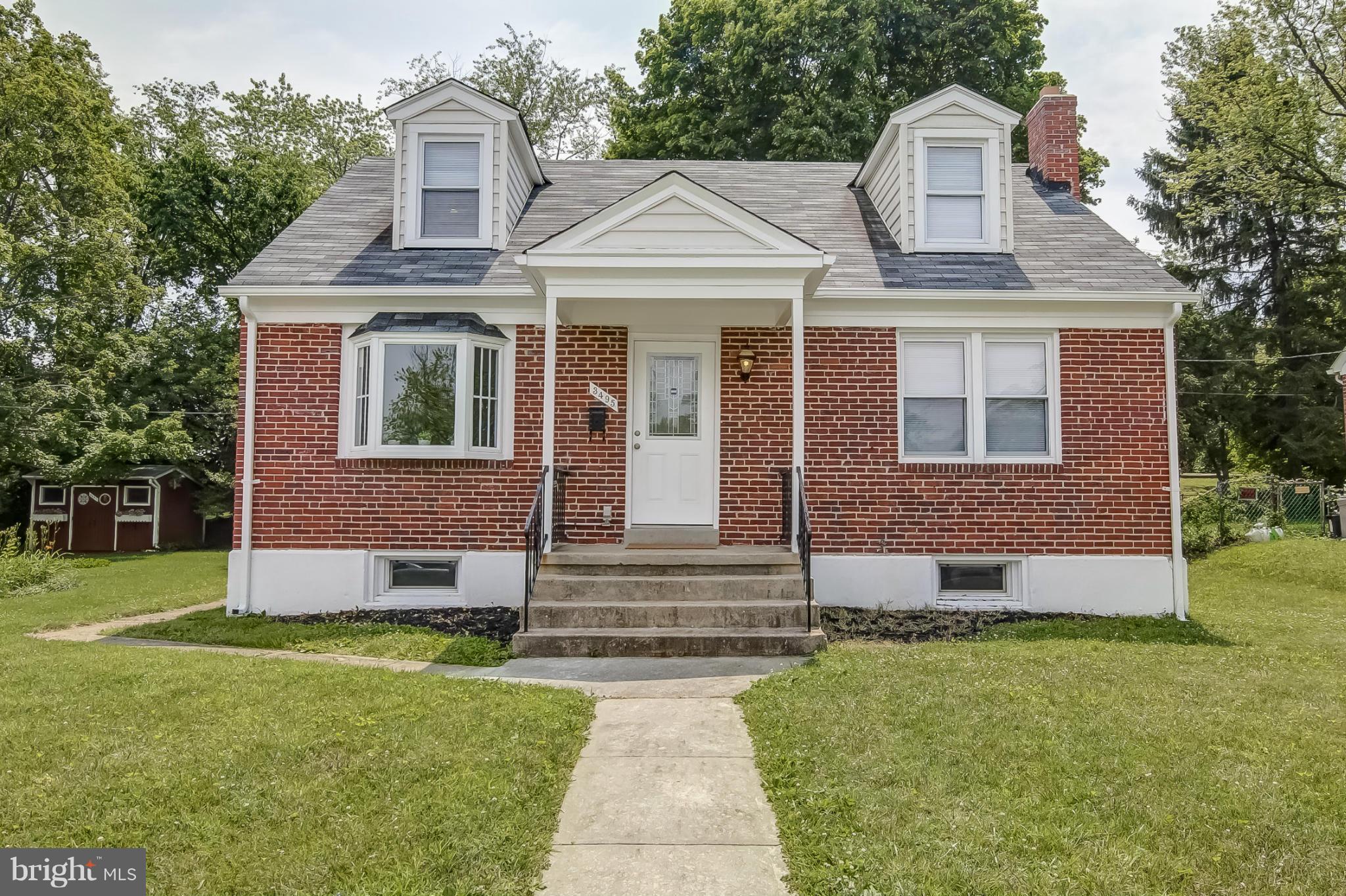 3495 Hillsmere Road Baltimore, MD 21207 - Photo 1 of 19 a front view of a house with garden