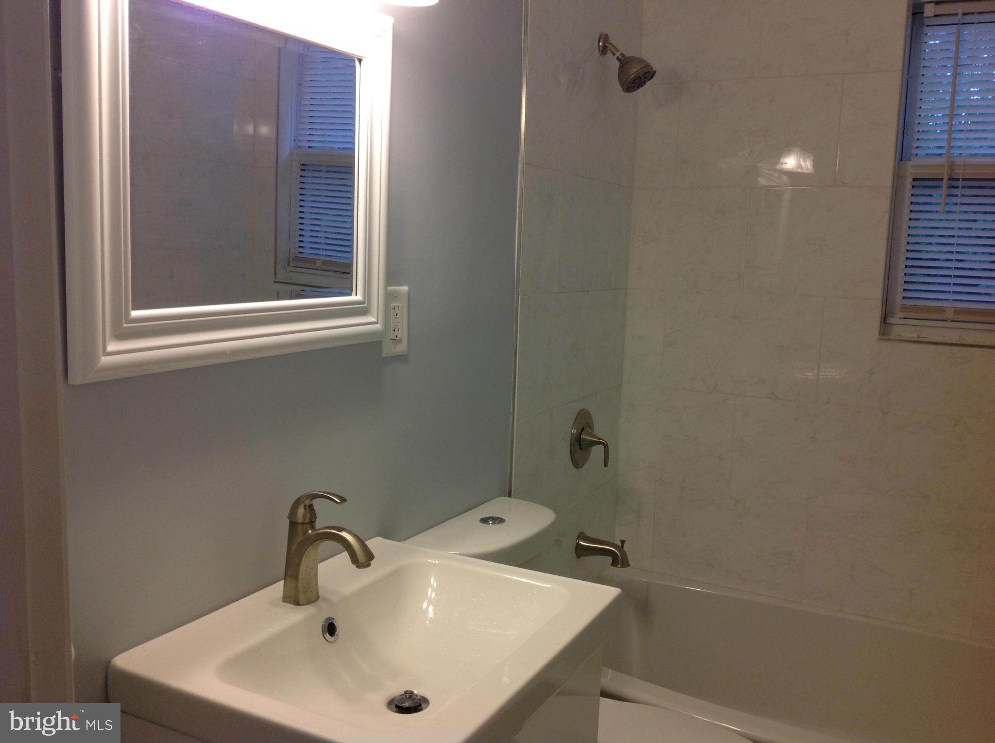 3495 Hillsmere Road Baltimore, MD 21207 - Photo 11 of 19 a bathroom with a sink and mirror