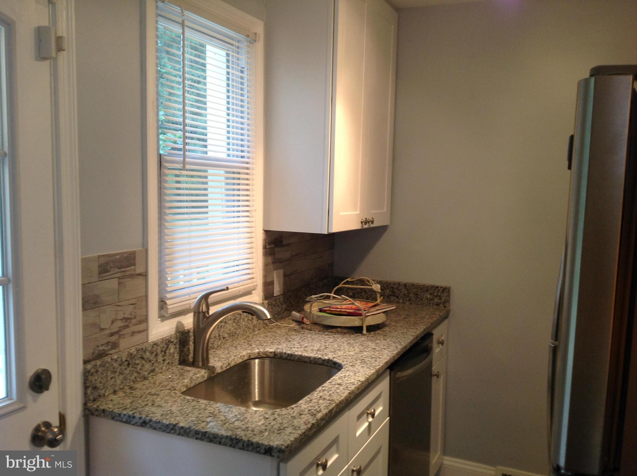 3495 Hillsmere Road Baltimore, MD 21207 - Photo 16 of 19 a kitchen with granite countertop a sink and a window