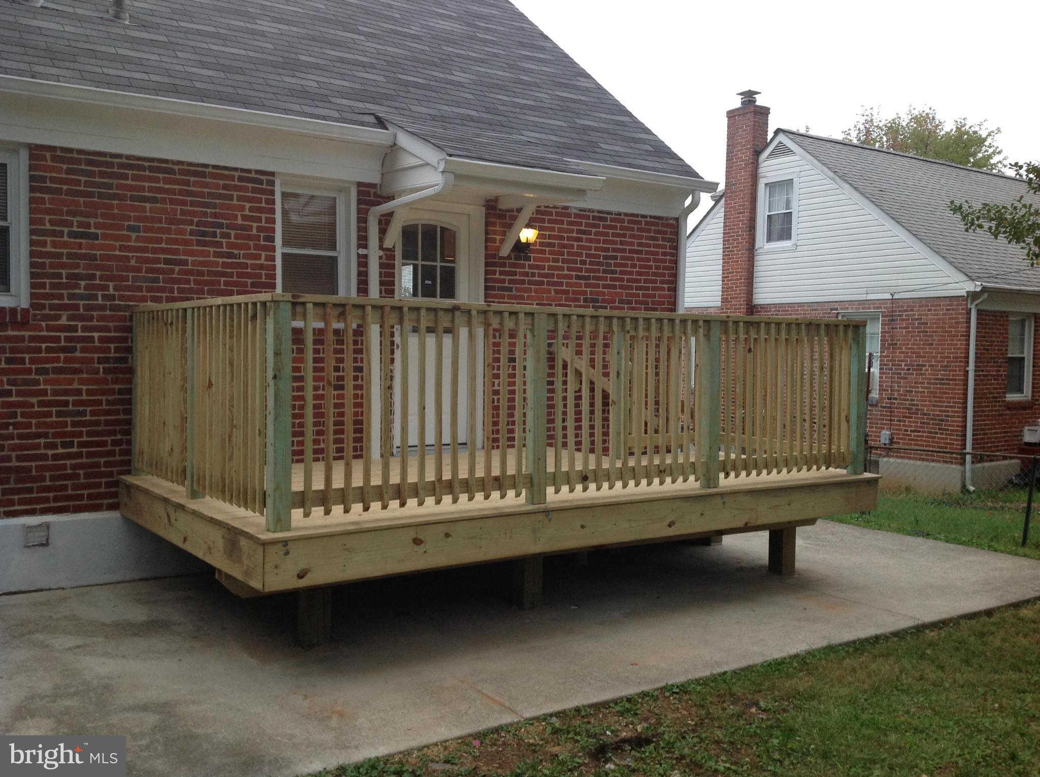3495 Hillsmere Road Baltimore, MD 21207 - Photo 19 of 19 a view of a house with a wooden deck and a yard