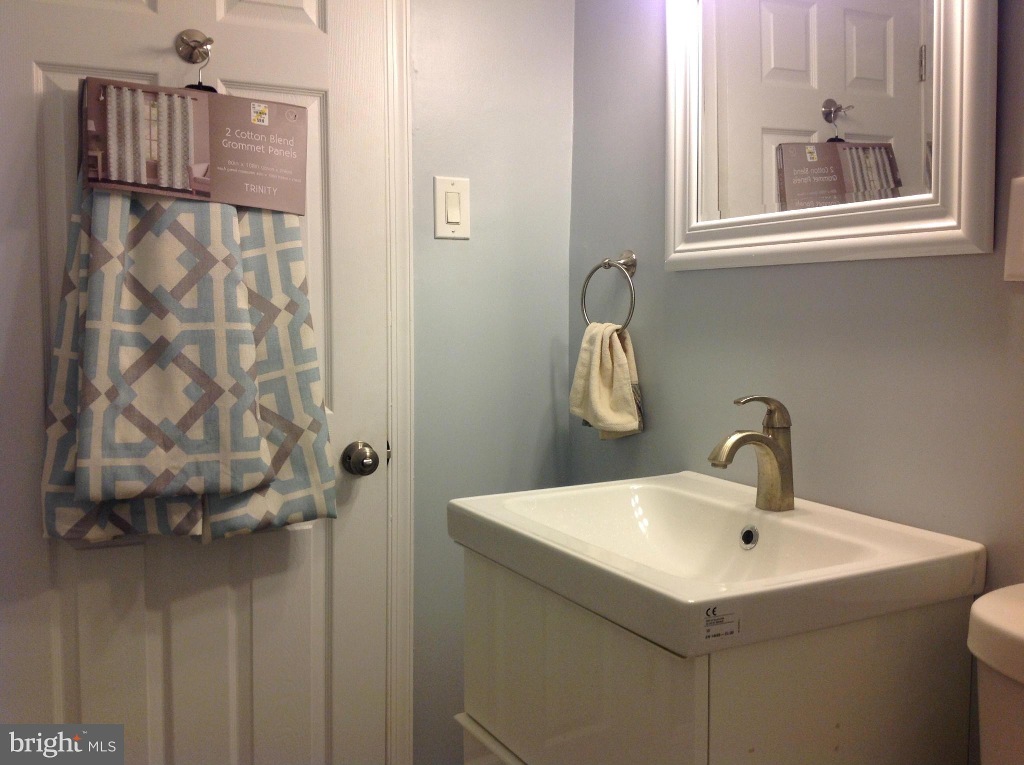 3495 Hillsmere Road Baltimore, MD 21207 - Photo 5 of 19 a bathroom with a sink and mirror