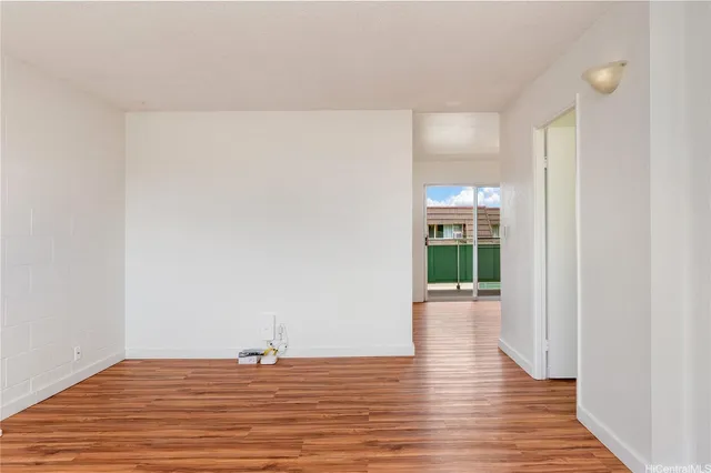 a view of a room with wooden floor and window
