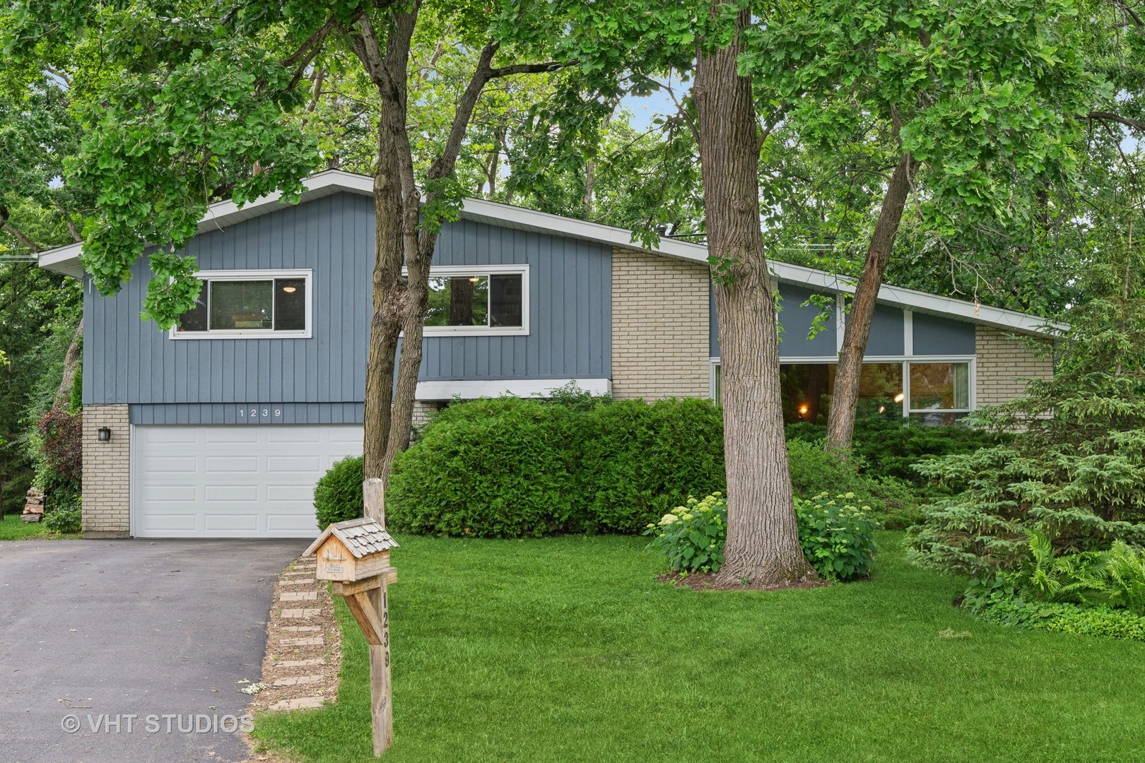 a front view of house with a garden