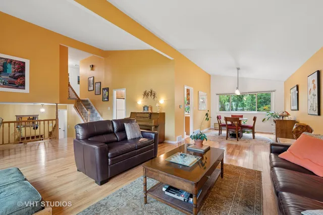 a living room with furniture fireplace and a table