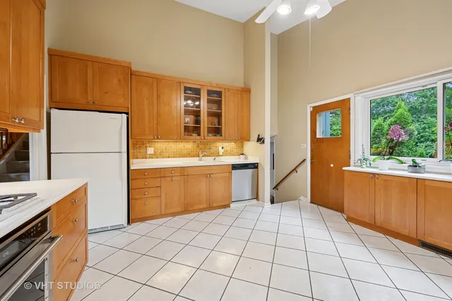 a kitchen with stainless steel appliances a refrigerator sink and cabinets