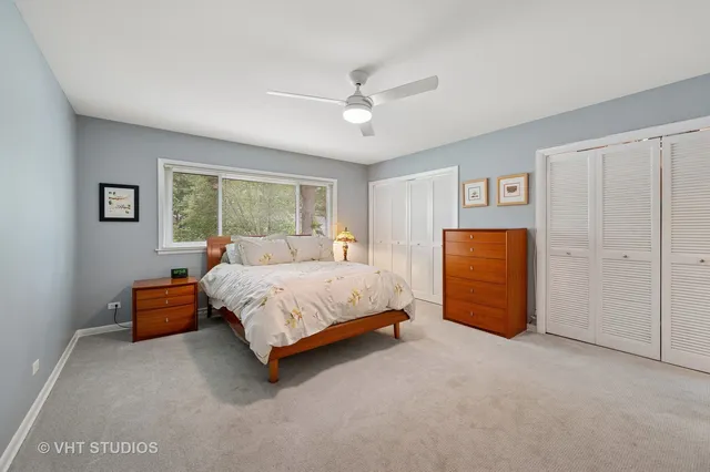 a spacious bedroom with a bed and a chandelier