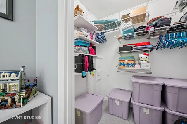 a utility room with lots of clutter and cabinets