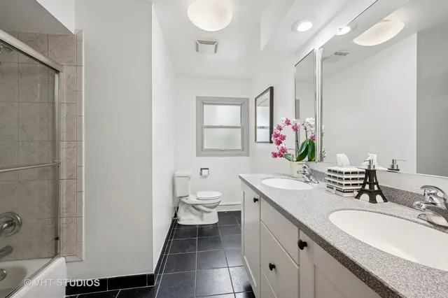 a bathroom with a sink double vanity and a mirror