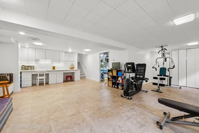 a view of a room with gym equipment and a large window