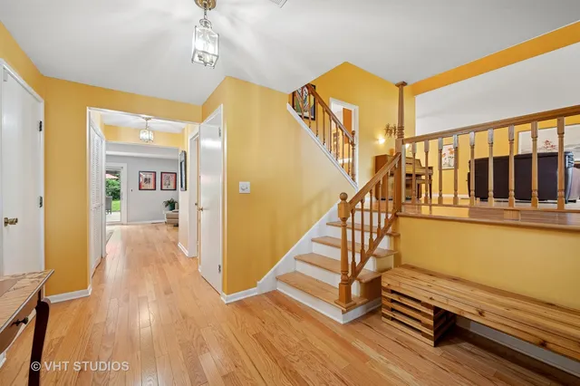 a view of a hallway with wooden floor and staircase