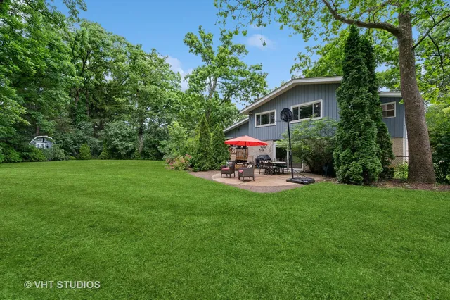 a view of a patio with table and chairs under an umbrella