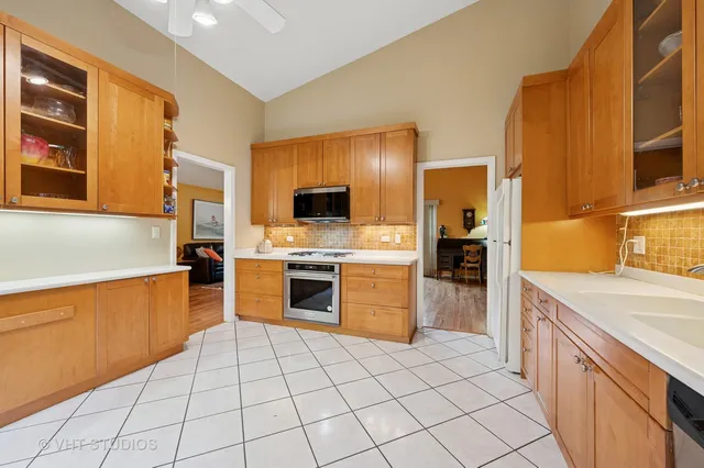 a kitchen with stainless steel appliances a stove sink and cabinets