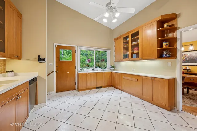 a kitchen with stainless steel appliances a cabinets and window