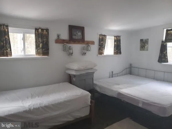 a bathroom with a sink toilet and window