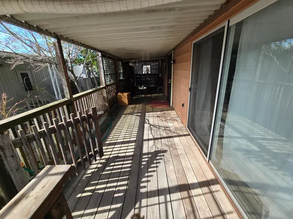 a view of balcony with wooden floor