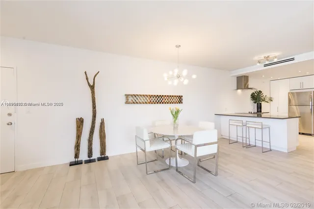 a dining room with furniture and a wooden floor
