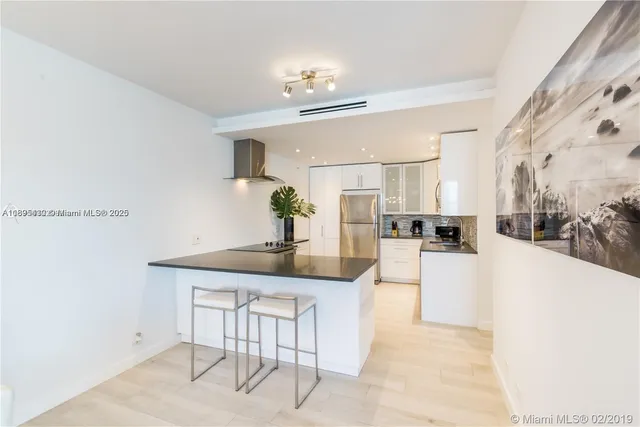 a living room with furniture and view of kitchen