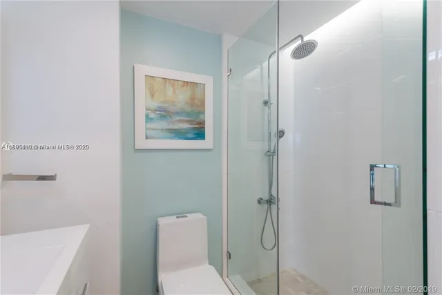 a bathroom with a toilet and a shower
