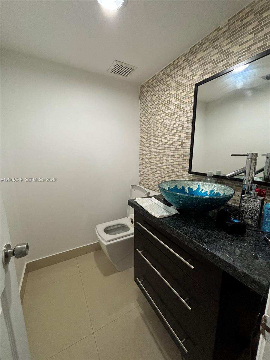 1351 Garden Road Weston, FL 33326 - Photo 12 of 20 a bathroom with a granite countertop sink and a toilet
