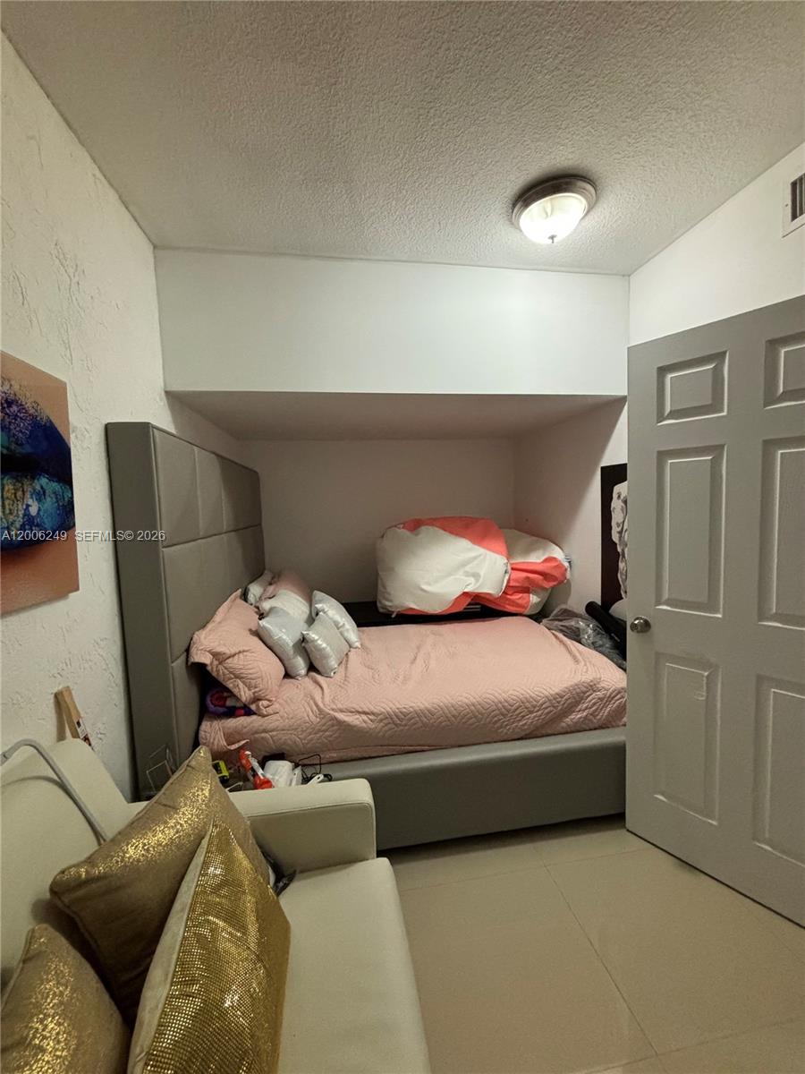 1351 Garden Road Weston, FL 33326 - Photo 14 of 20 a bedroom with a bed and window