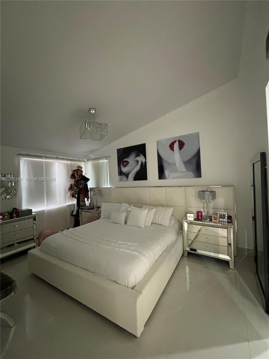1351 Garden Road Weston, FL 33326 - Photo 15 of 20 a bedroom with a bed and lamp