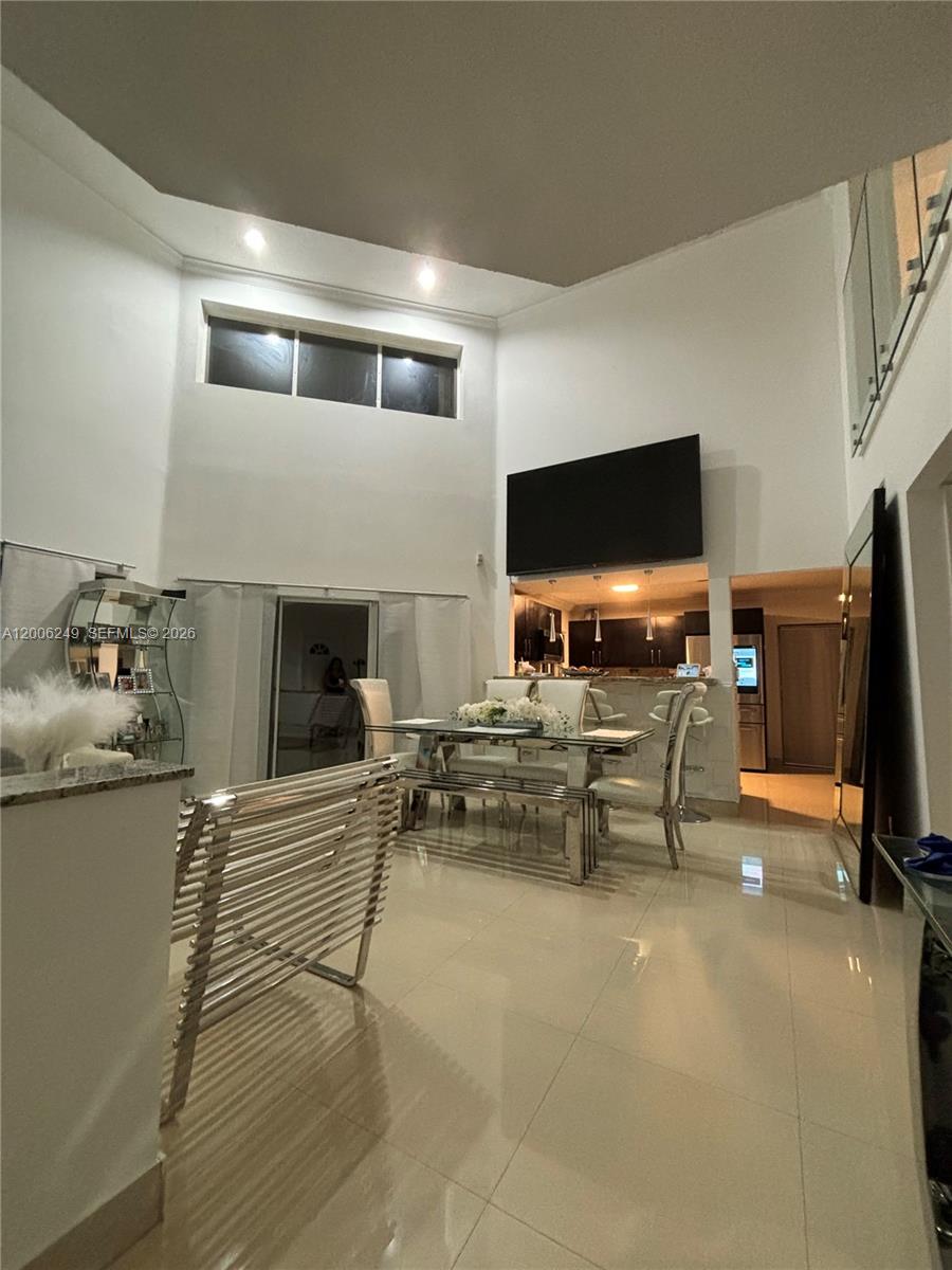 1351 Garden Road Weston, FL 33326 - Photo 4 of 20 a living room with furniture and a flat screen tv