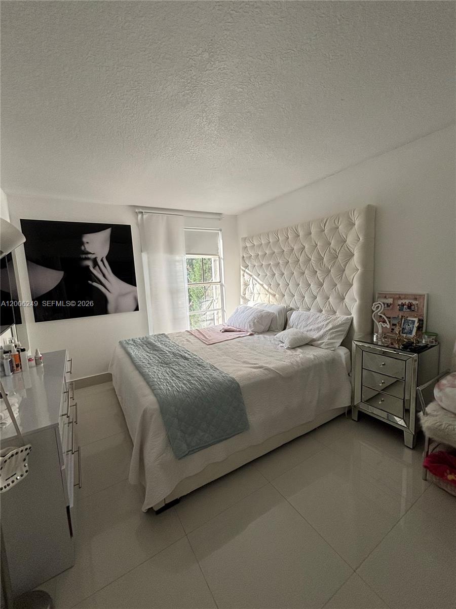 1351 Garden Road Weston, FL 33326 - Photo 10 of 20 a bedroom with a bed and a dresser