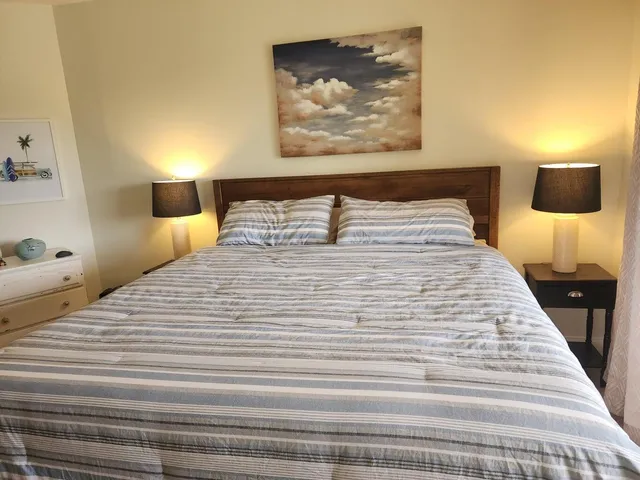 a bedroom with a bed and a large window