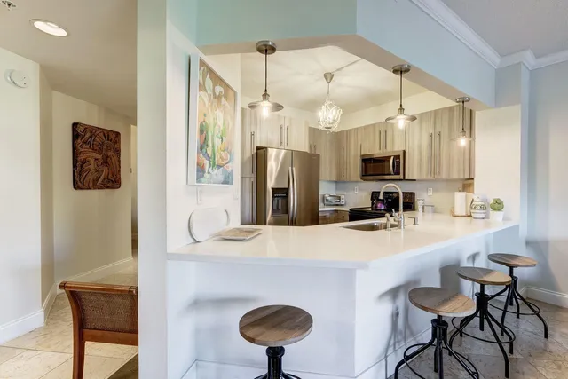 a living room with furniture a lamp and a large window