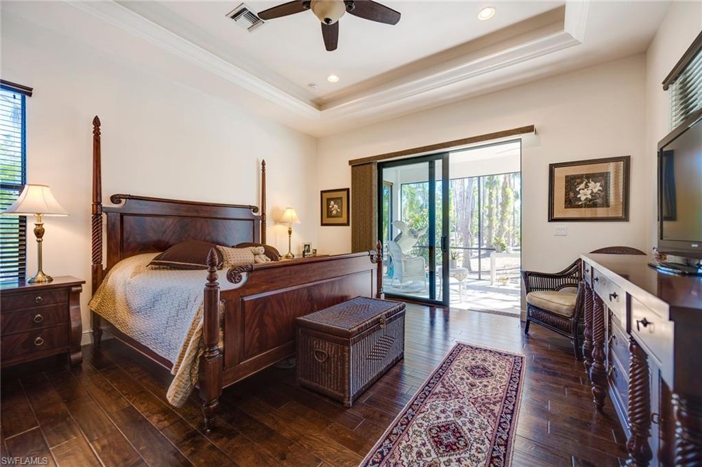 6010 Bur Oaks Lane Naples, FL 34119 - Photo 11 of 23 a bed room with a bed and a couch