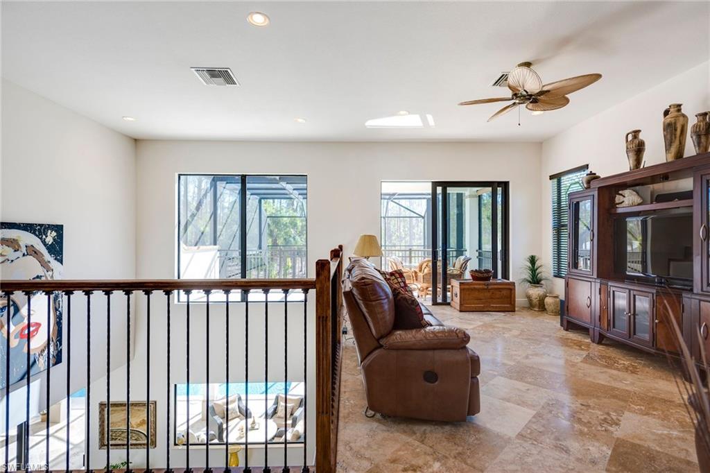 6010 Bur Oaks Lane Naples, FL 34119 - Photo 15 of 23 a living room with furniture and a flat screen tv