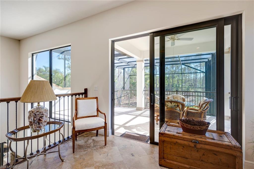 6010 Bur Oaks Lane Naples, FL 34119 - Photo 16 of 23 a living room with furniture and a floor to ceiling window
