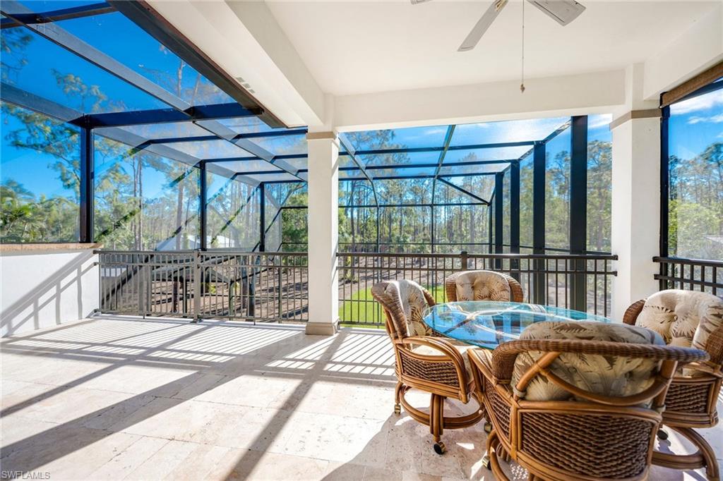 6010 Bur Oaks Lane Naples, FL 34119 - Photo 17 of 23 a living room with furniture and a floor to ceiling window